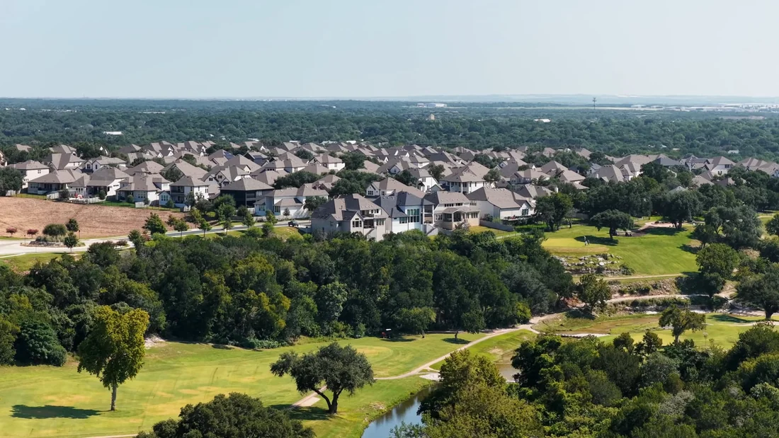 Aerial view over a green neighborhood and landscape