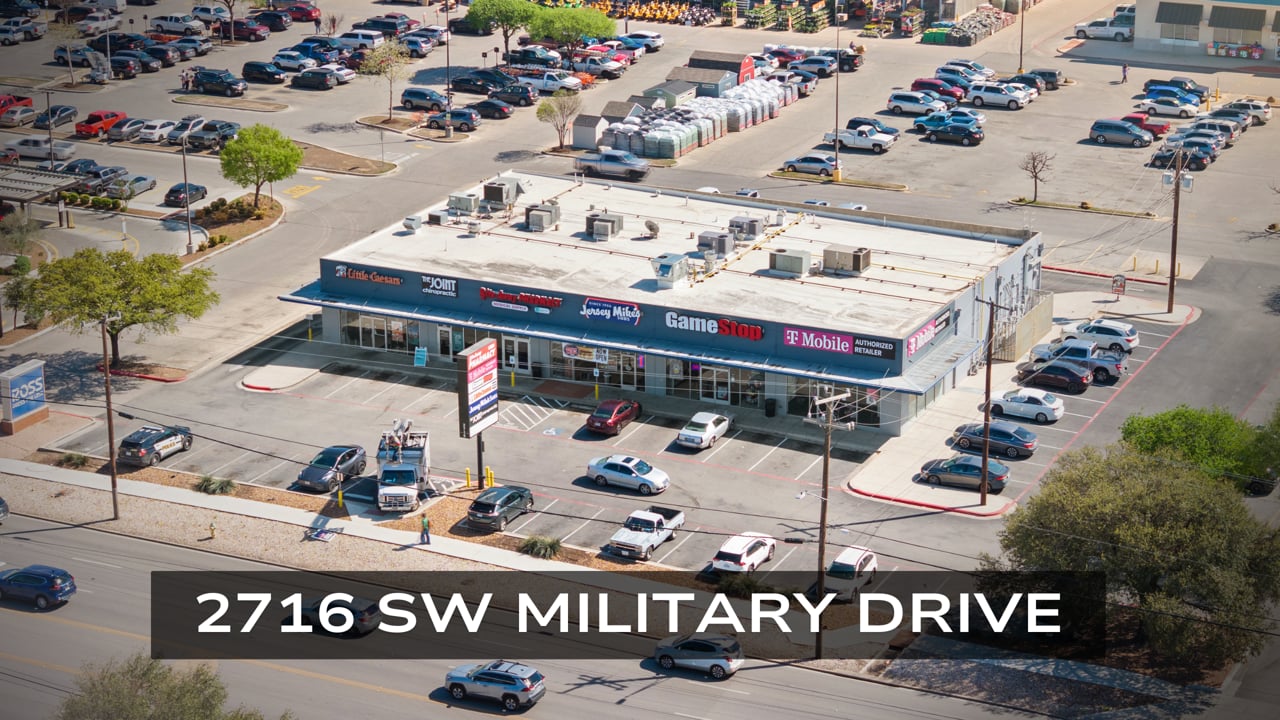 Aerial view of a San Antonio retail strip center, parking, and surrounding roads