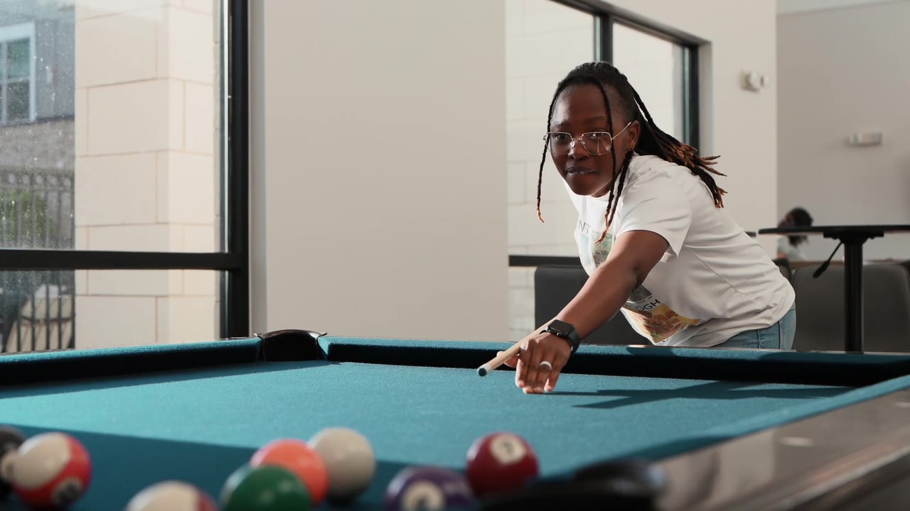 Resident playing pool at Axis at Watters Creek
