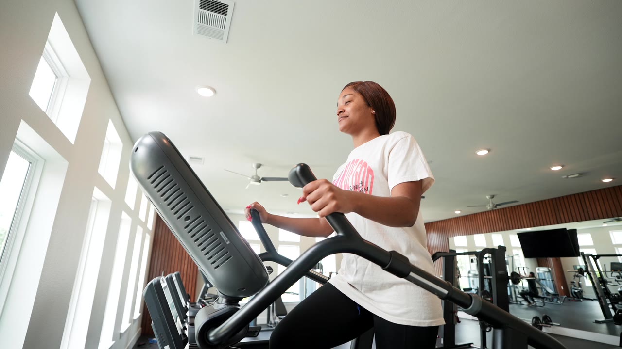 Resident exercising in the Eleven West fitness room