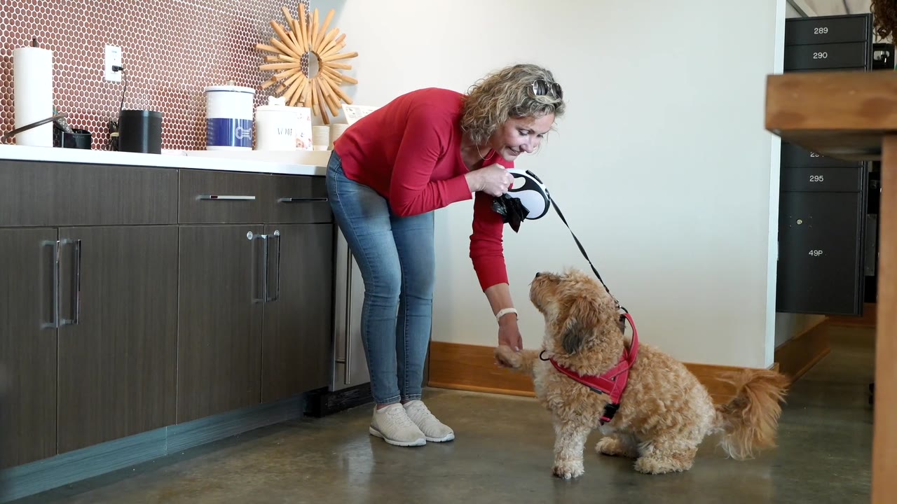 Resident greeting a dog at The Donovan