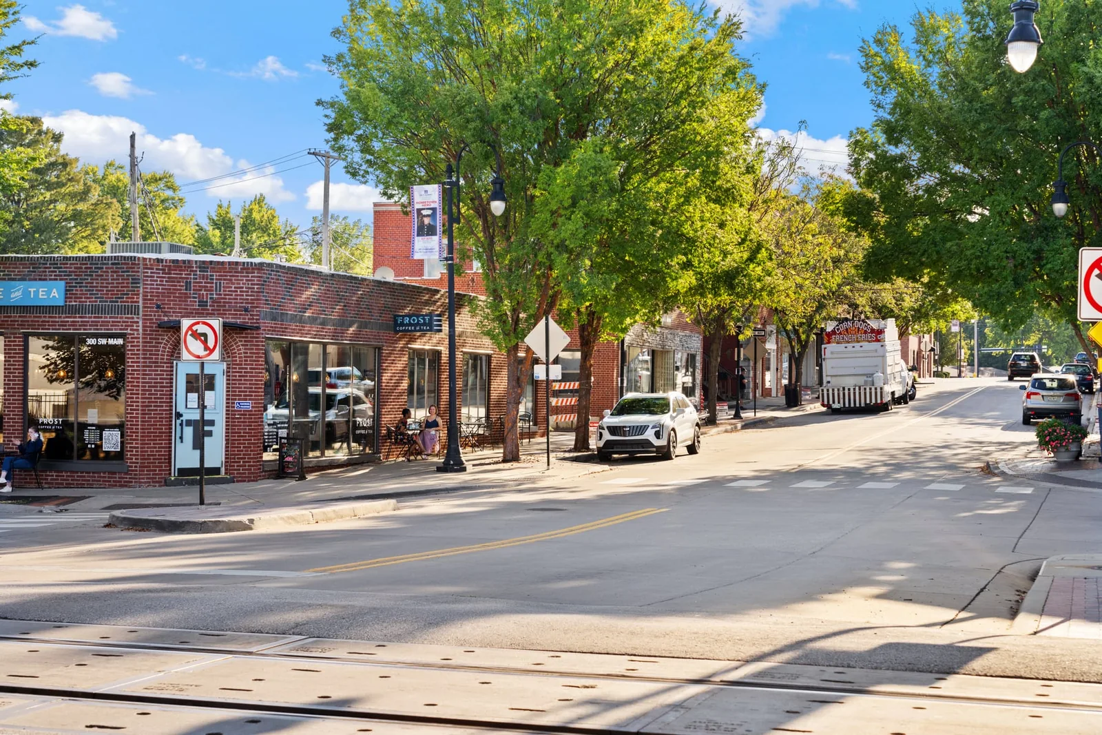 Tree-lined downtown street with storefronts