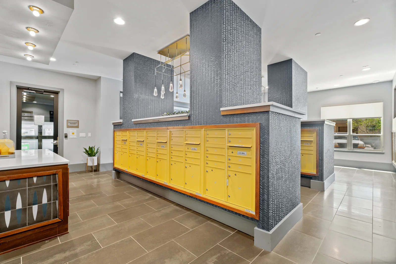 Apartment community common area with yellow cabinetry and tiled floor