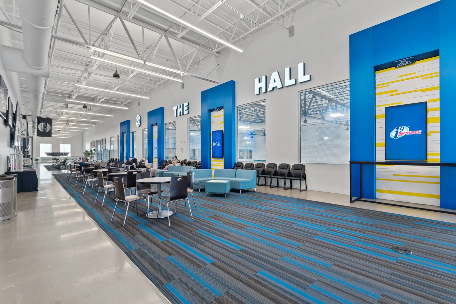 Indoor recreation hall with seating and a colorful entrance