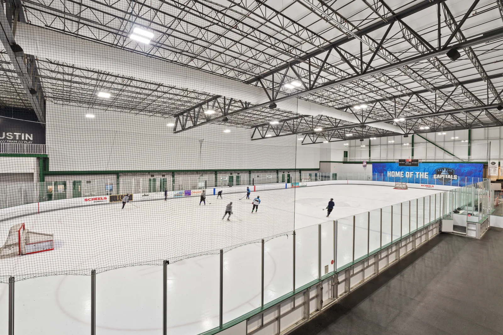 Indoor ice rink beneath a steel truss ceiling