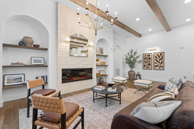 Light-filled living room with timber beams and a limestone fireplace