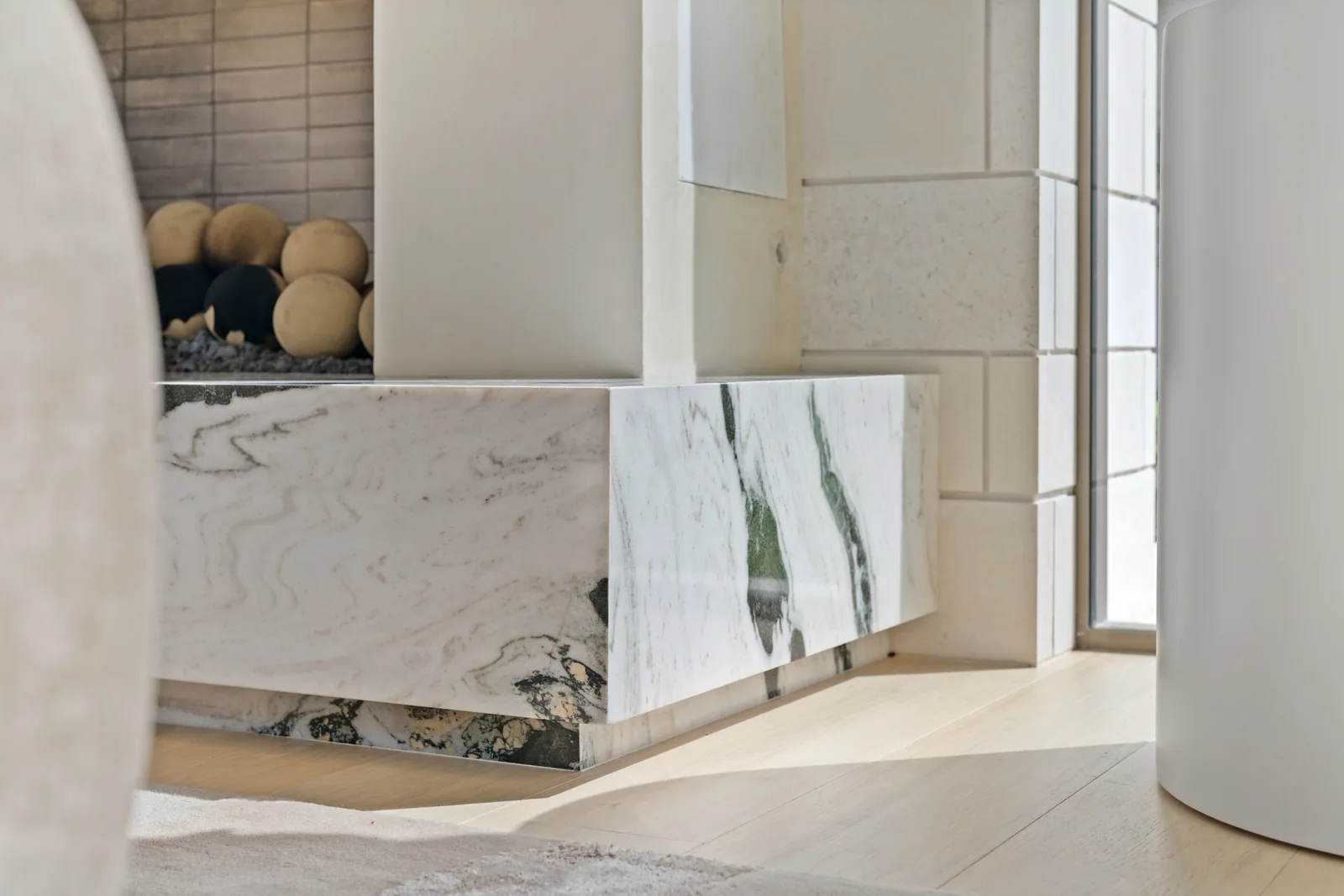 Marble fireplace surround and hearth beside a tall window