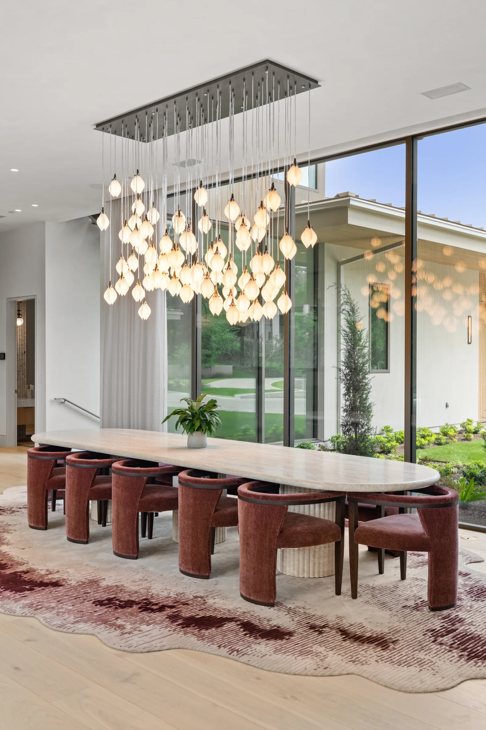 Dining room with a statement chandelier and floor-to-ceiling windows