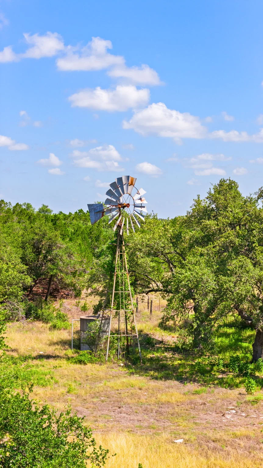 Windmill among trees on a Central Texas property