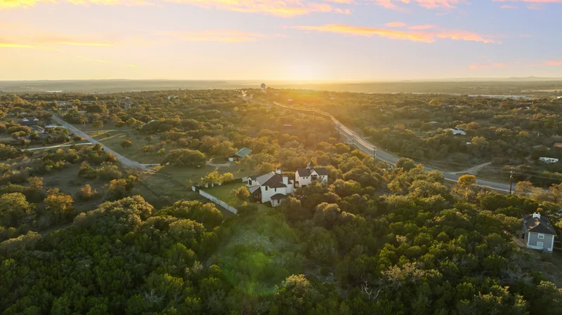 Aerial view over a wooded neighborhood at sunset