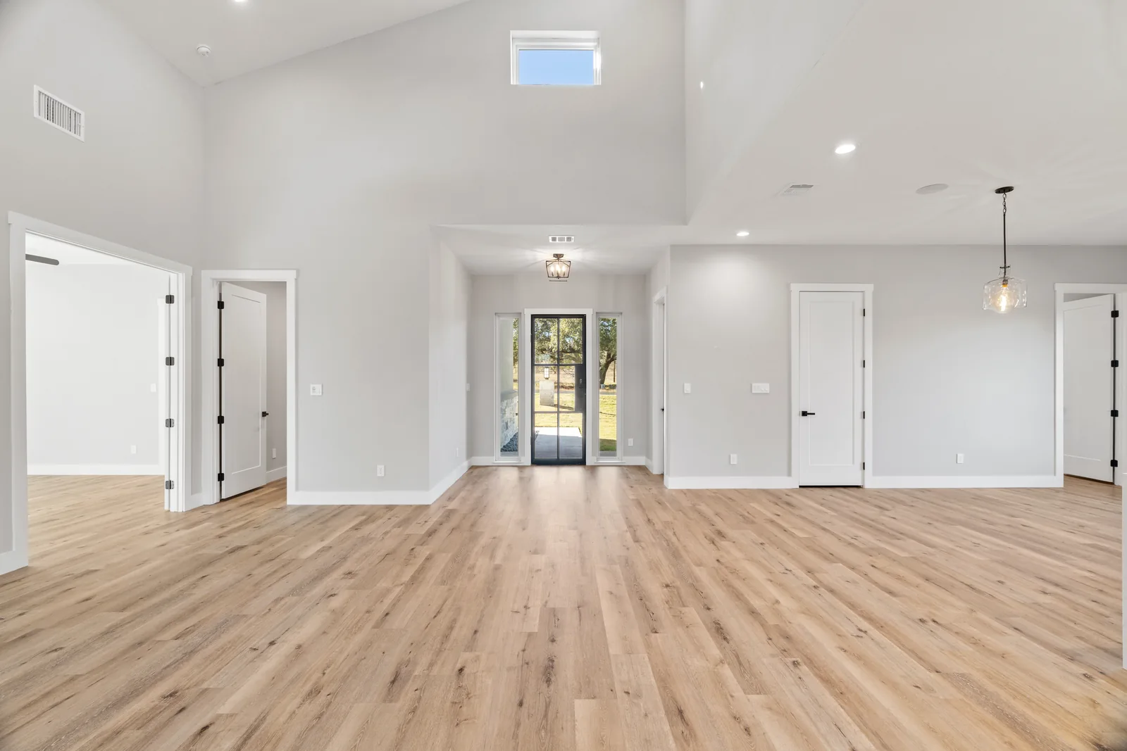 Unfurnished living room with light wood flooring and white walls