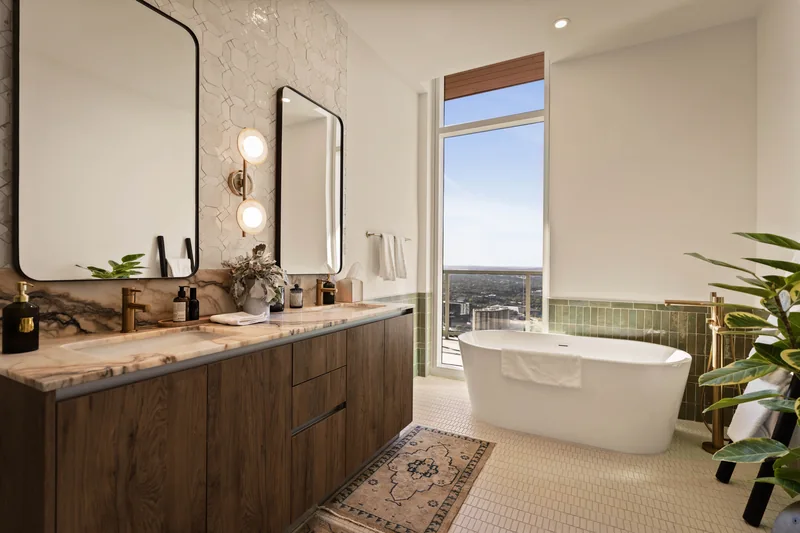 High-rise apartment bathroom with a freestanding tub and city view