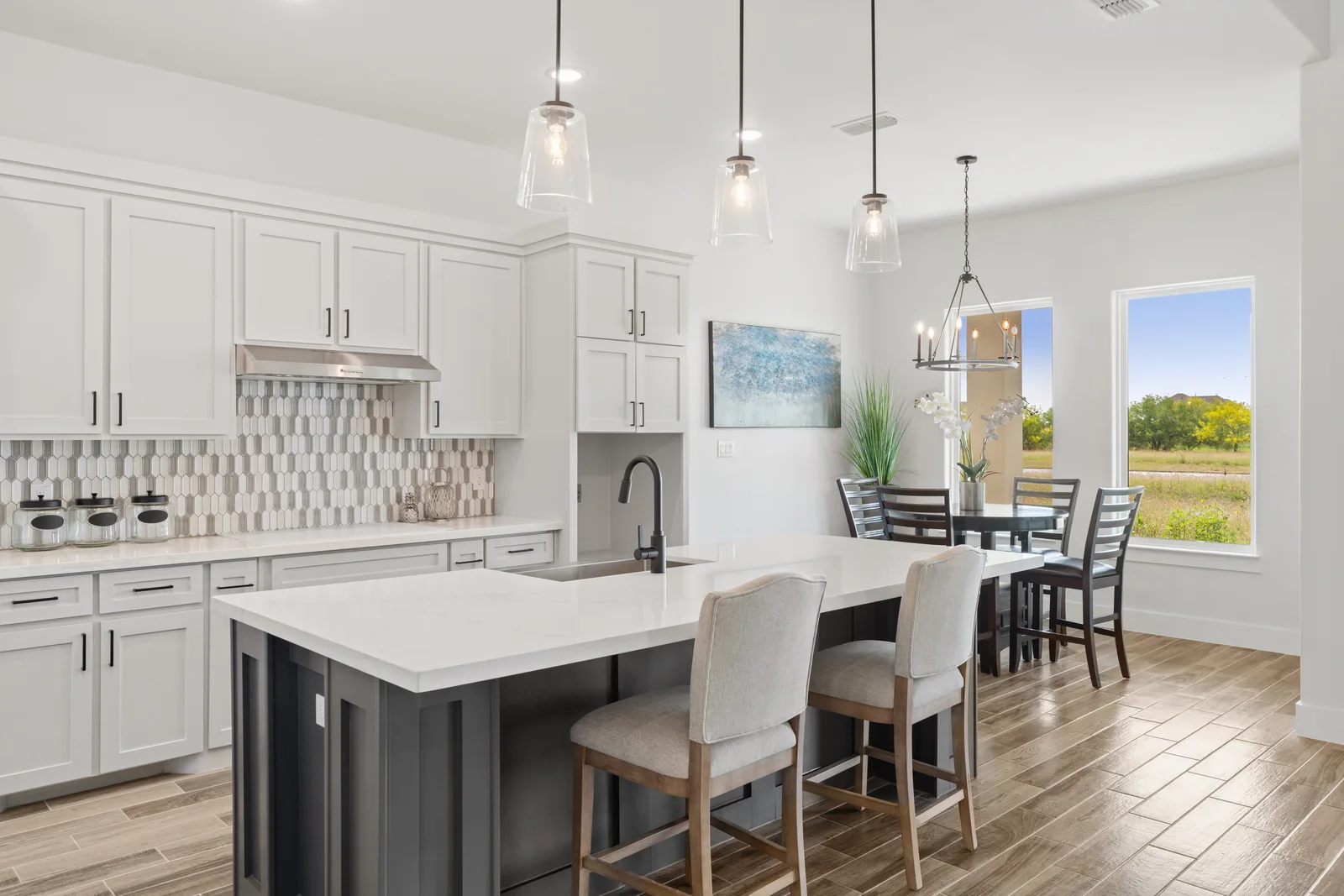 White kitchen with patterned tile and a dark island
