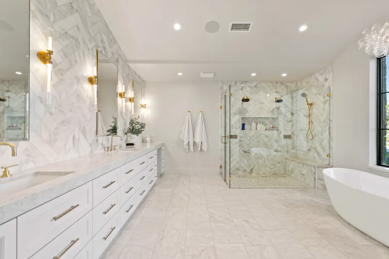 Bright bathroom with a freestanding tub and patterned stone floor
