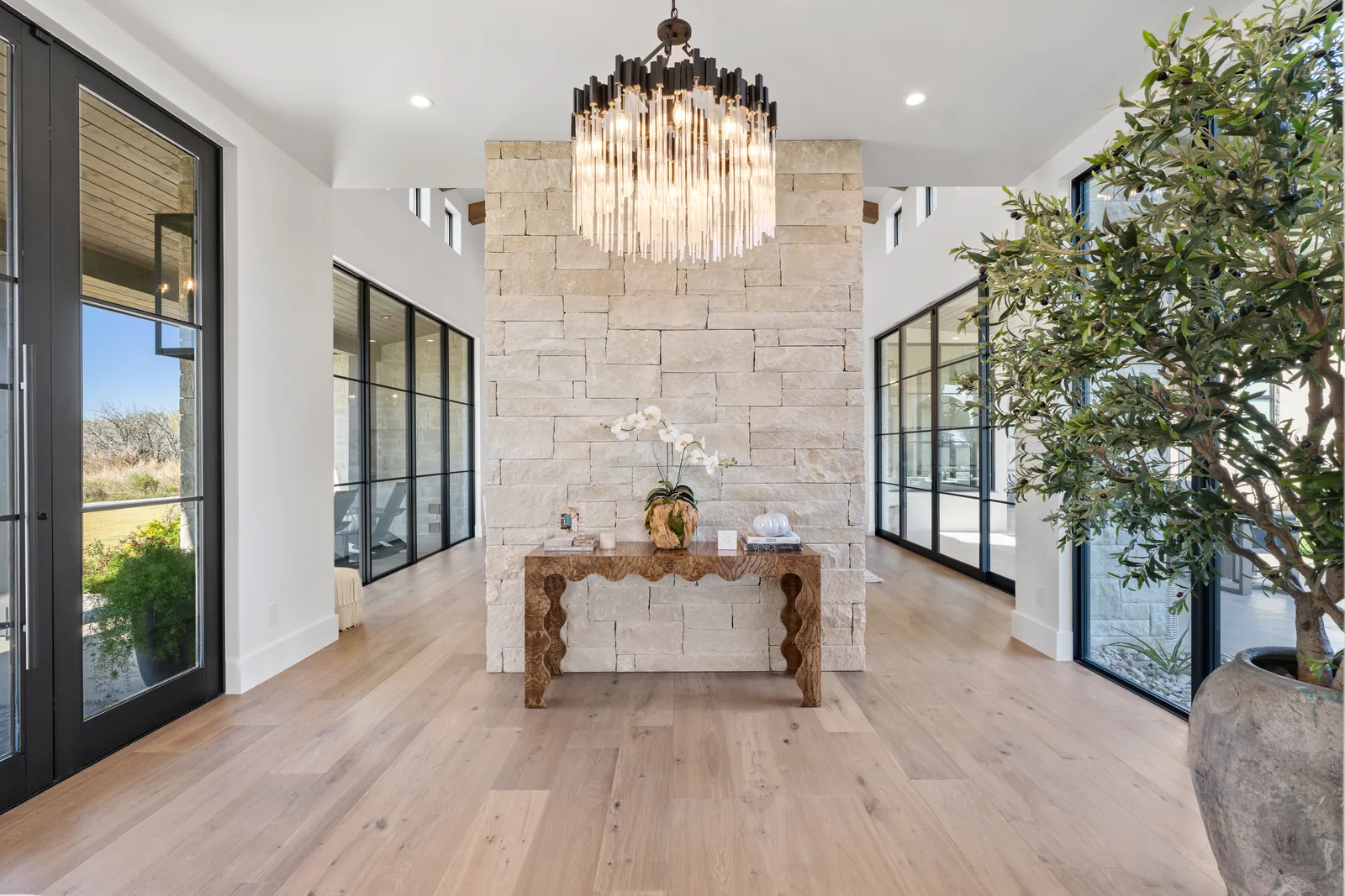 Entry hall with stone feature wall and two windowed corridors