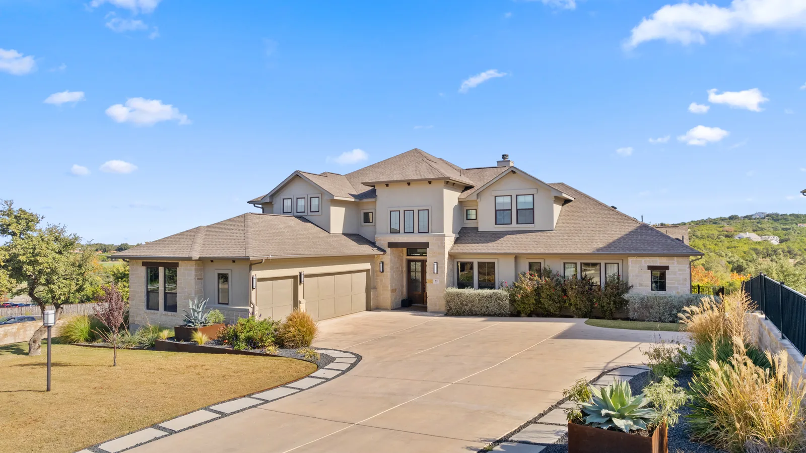 Two-story home with a wide driveway and landscaped front yard