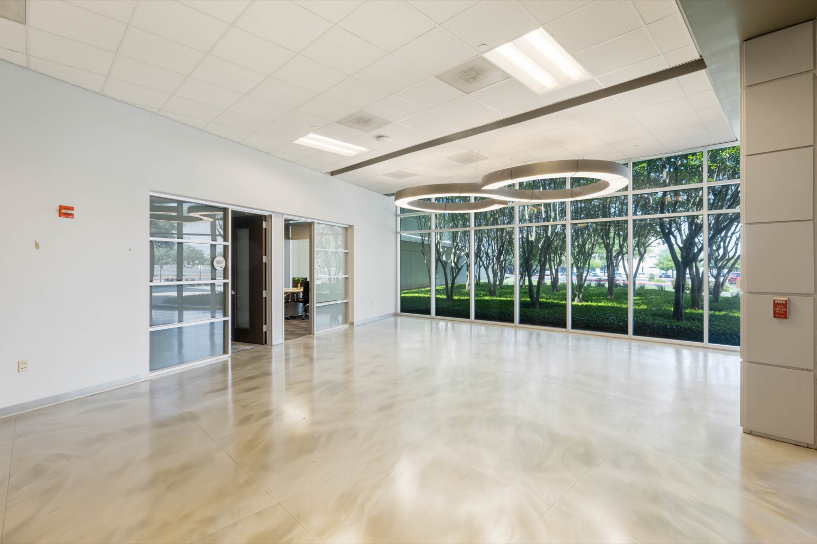 Bright glass-fronted lobby with views of trees outside