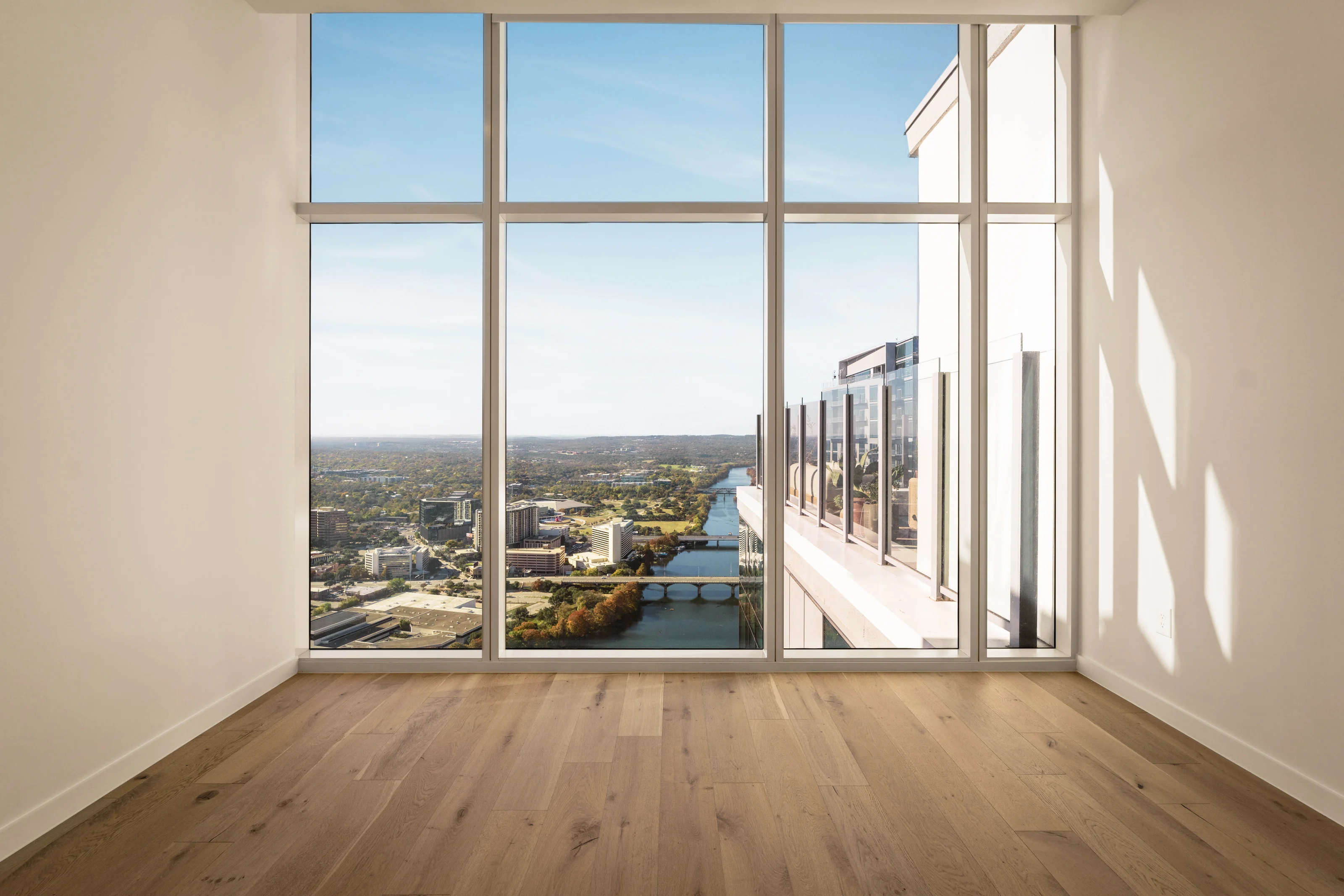 Floor-to-ceiling windows overlooking Lady Bird Lake from an Austin high-rise
