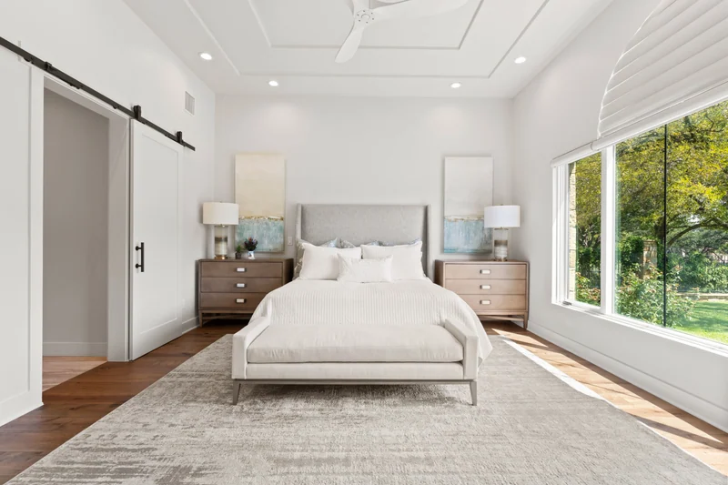 Bedroom with large windows and warm neutral finishes