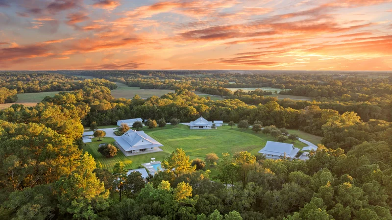 Golden evening light over the homes, fields, and trees of Whitehall Ranch