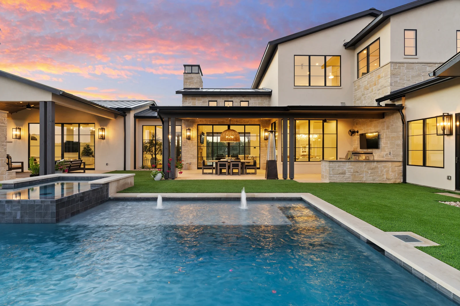 A contemporary home and illuminated pool at 2137 Parkview Drive, photographed at twilight