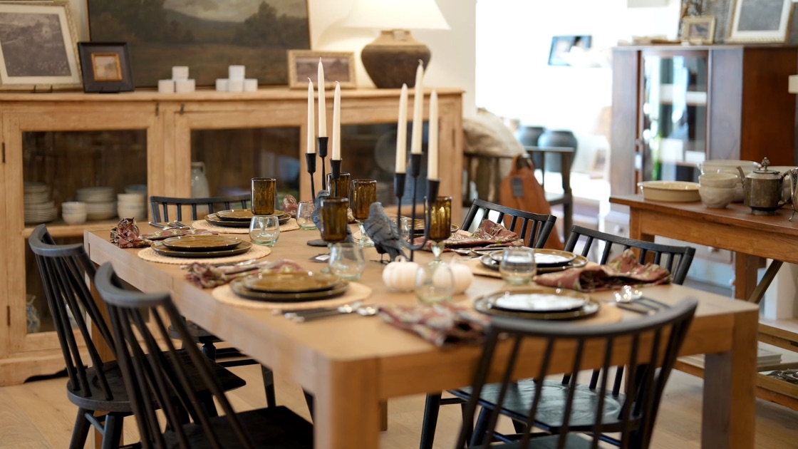A table and home goods on display inside Heirloom Shoppe