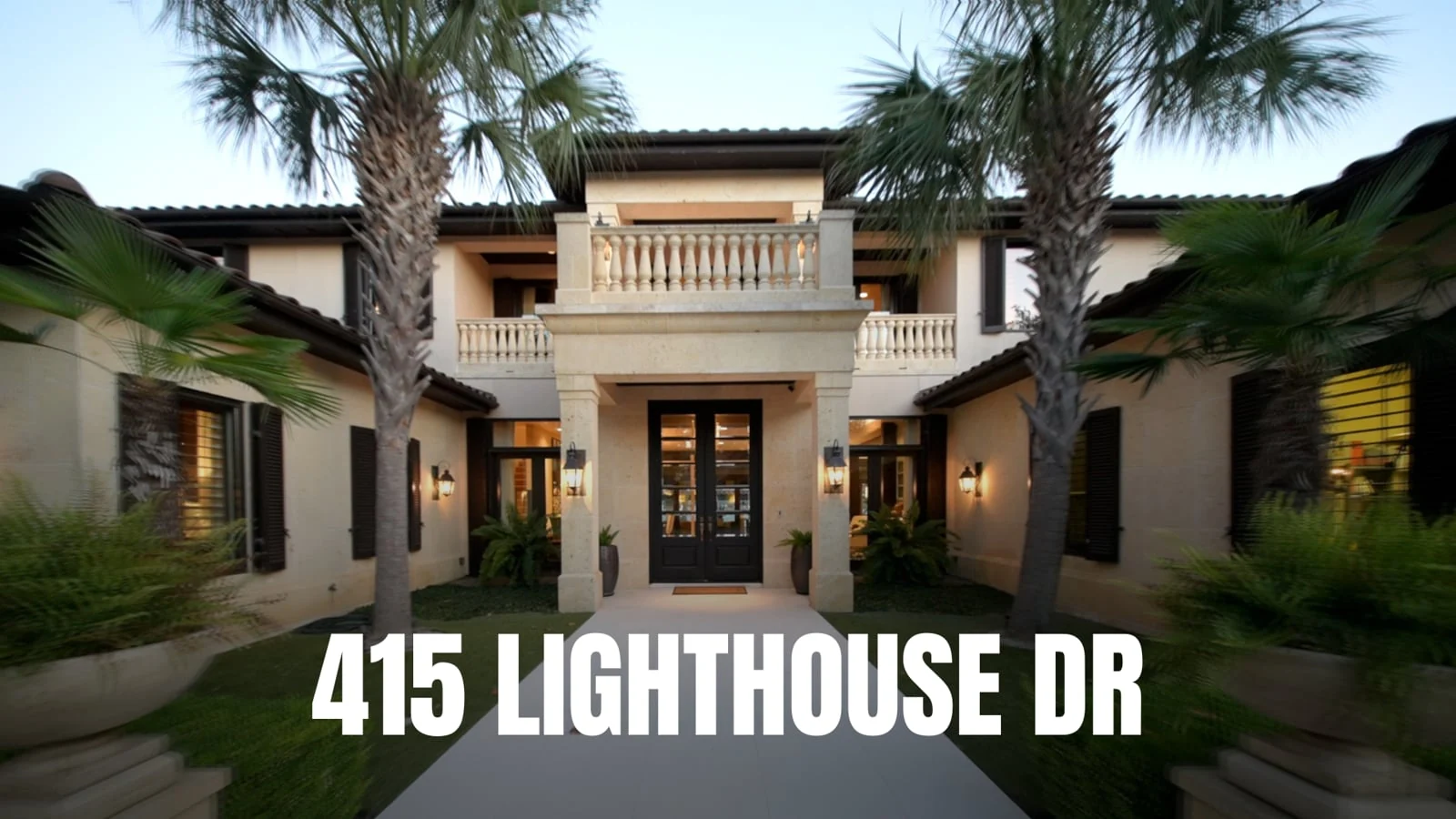 The palm-lined entrance of 415 Lighthouse Drive, from the property film