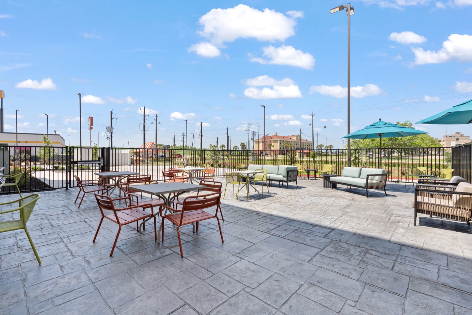 Hotel outdoor patio with tables and lounge seating
