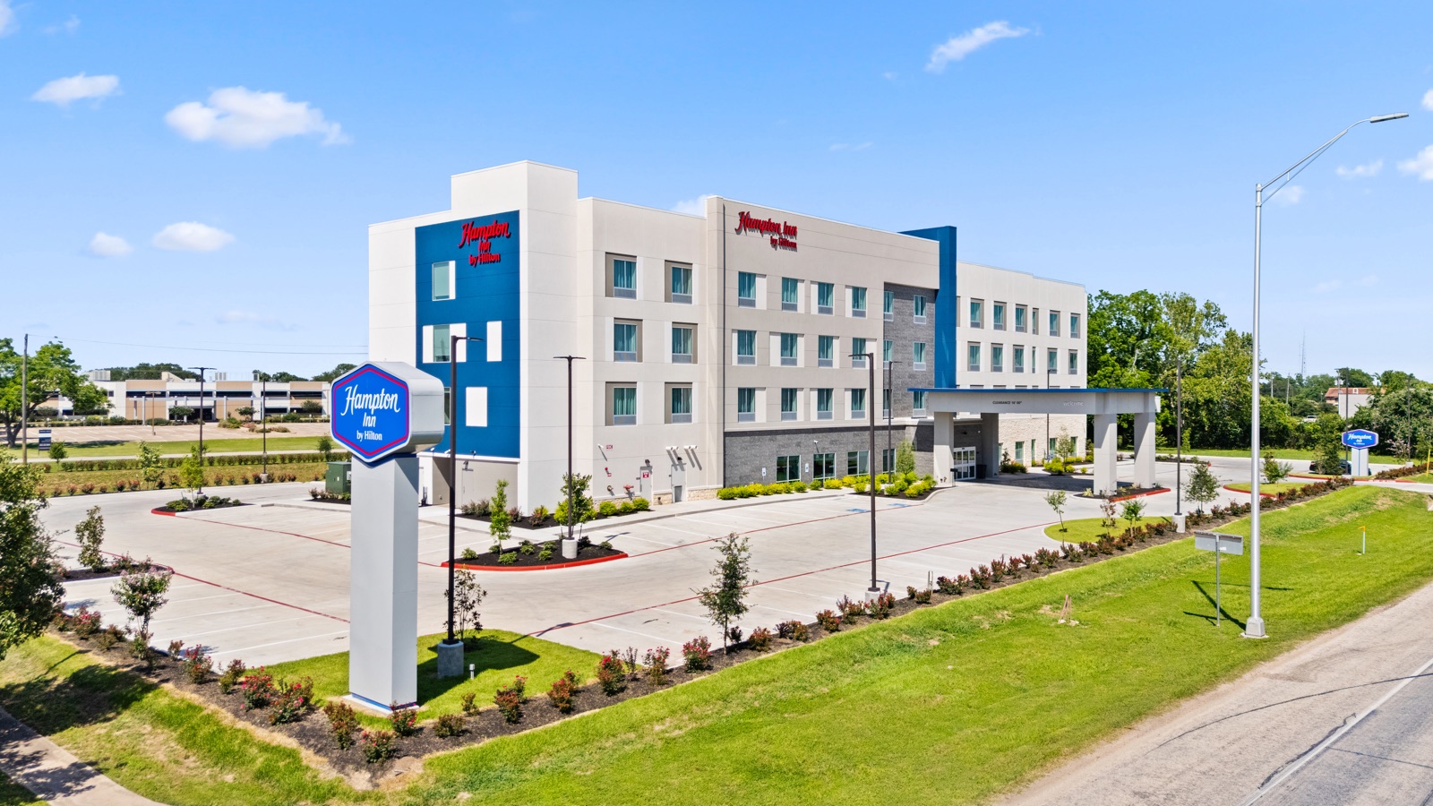 Elevated daytime view of Hampton Inn exterior and arrival drive