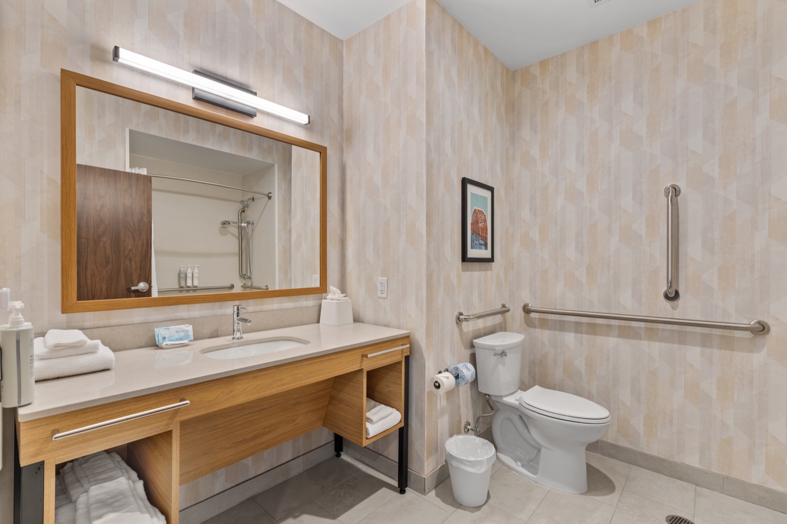 Accessible hotel guest bathroom with vanity and shower
