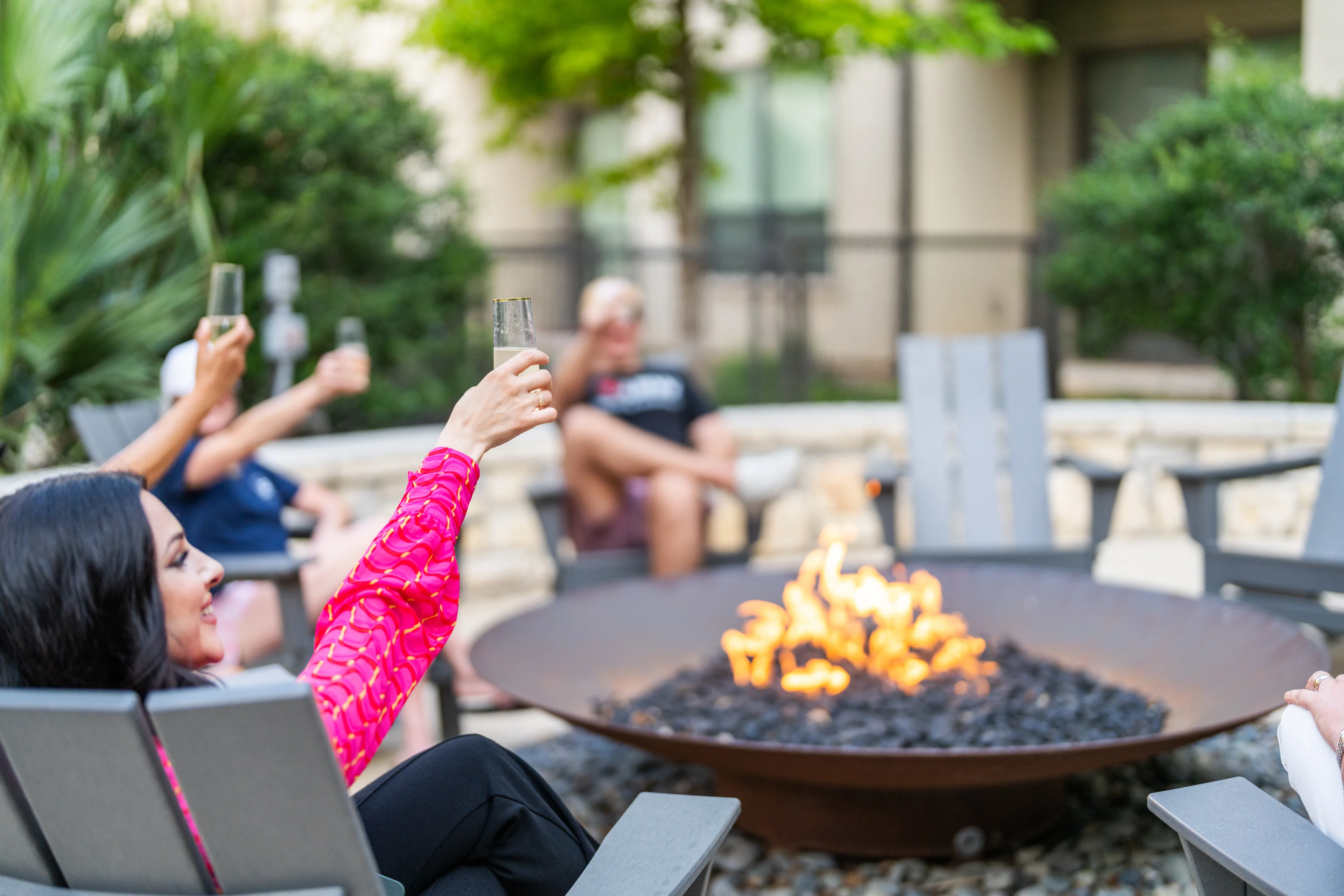 Neighbors sharing an evening around a courtyard firepit