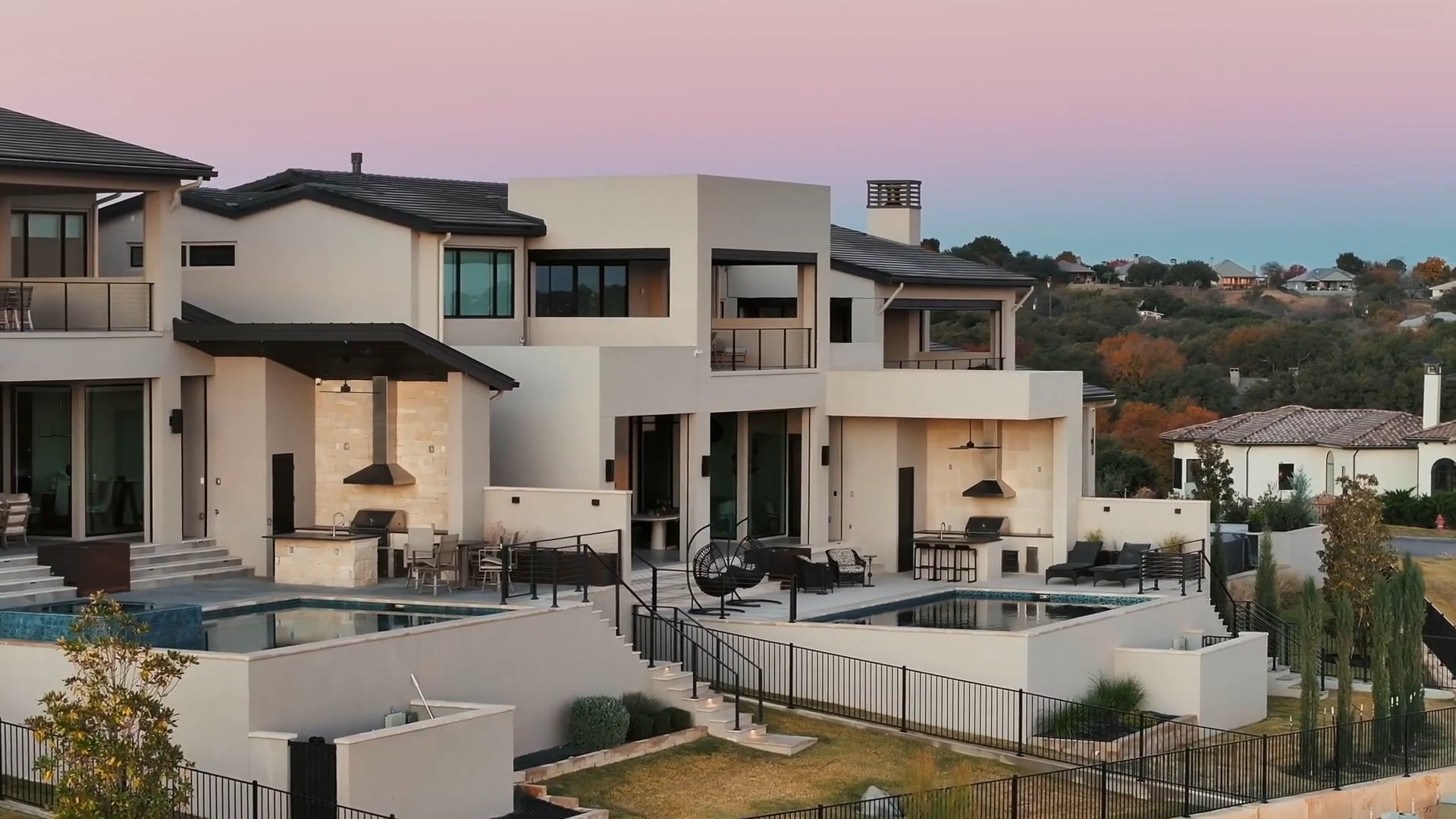 Lakeside home and swimming pools at dusk, from the Austin 360 studio reel