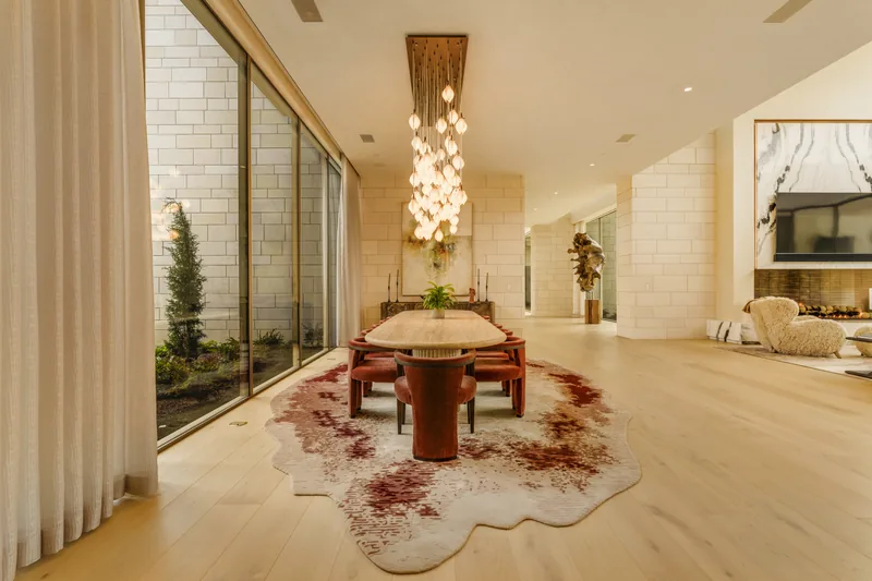 Long Bennedict Lane interior with stone walls, timber flooring and a sculptural pendant