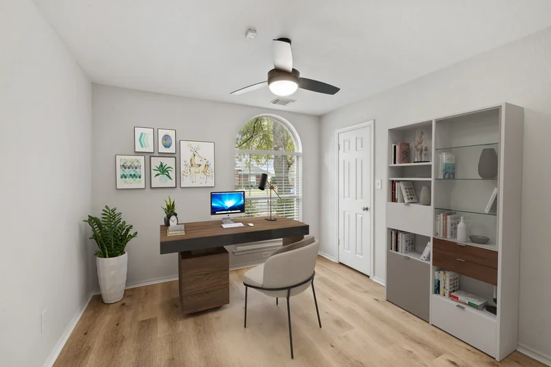 The same study with a desk, shelving, chair and artwork added digitally