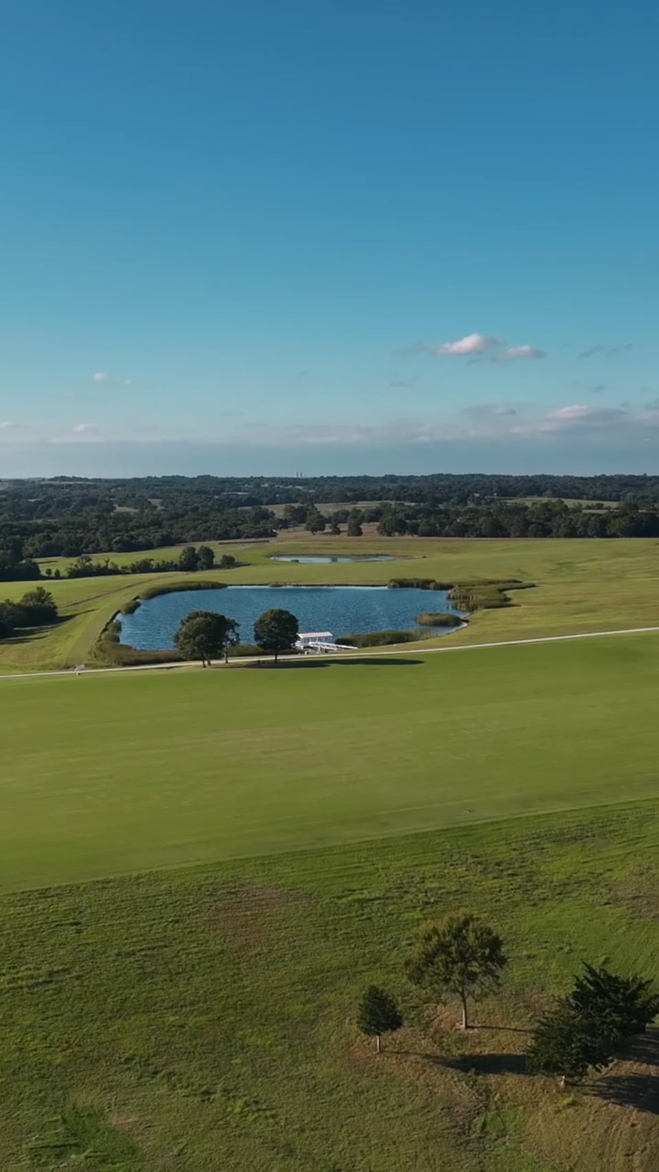 Aerial portrait of a ranch pond among open pasture