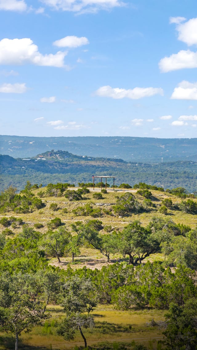 Hill Country ranch landscape beneath a wide sky