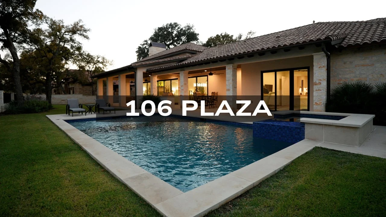 Twilight pool and illuminated home at 106 Plaza, from the property film