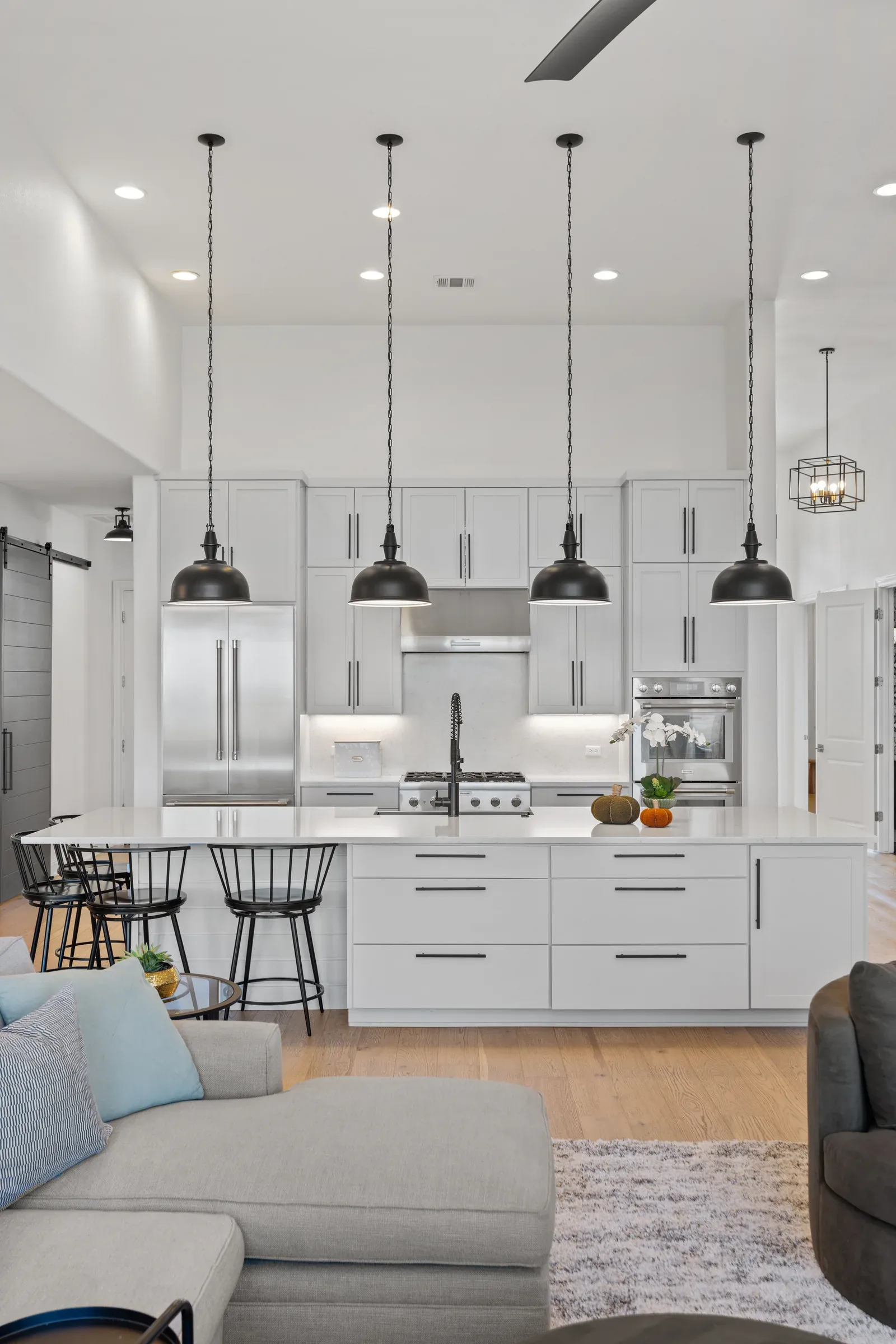 Light-filled kitchen with pendant lights and a long island