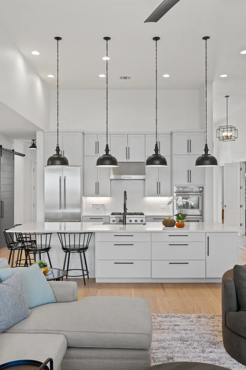 Light-filled kitchen with pendant lights and a long island