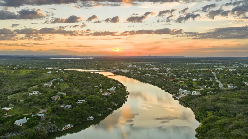 Marble Falls bridge reflected in the water at sunset