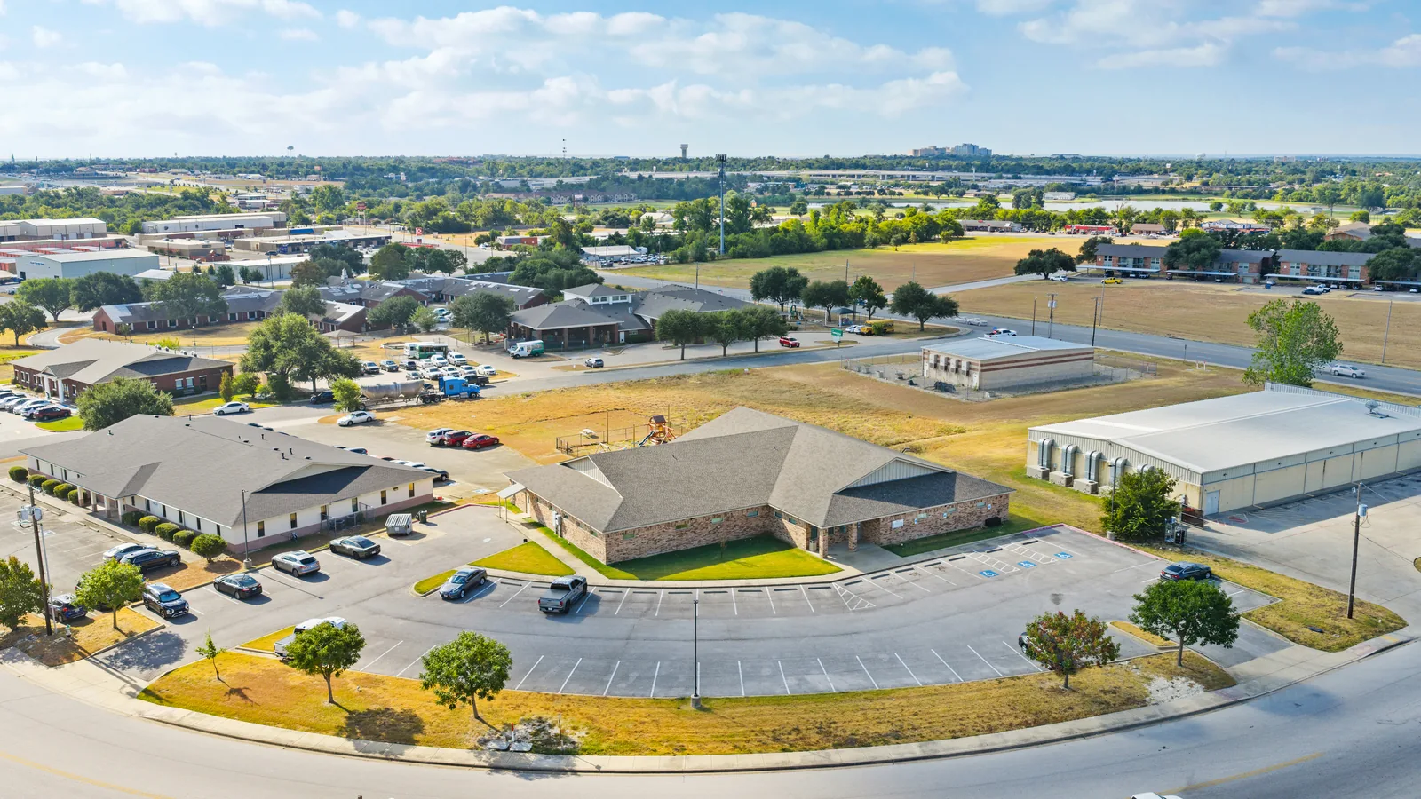 Aerial view of commercial buildings, parking and roads in Temple