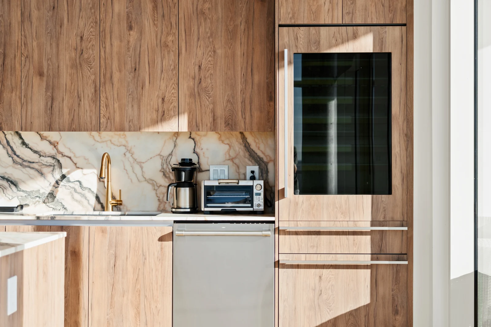 Warm wood kitchen with clean lines and a long island