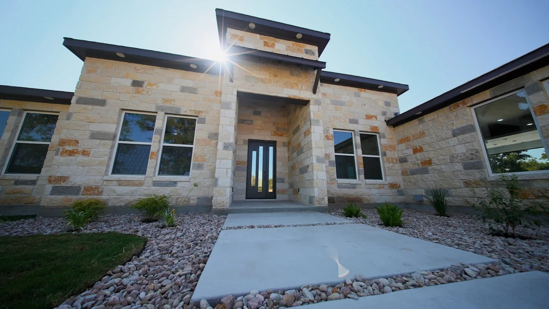 Stone-front home catching the late afternoon sunlight