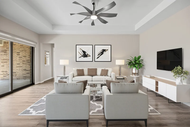 The same living room with sofas, chairs, art and decor added digitally