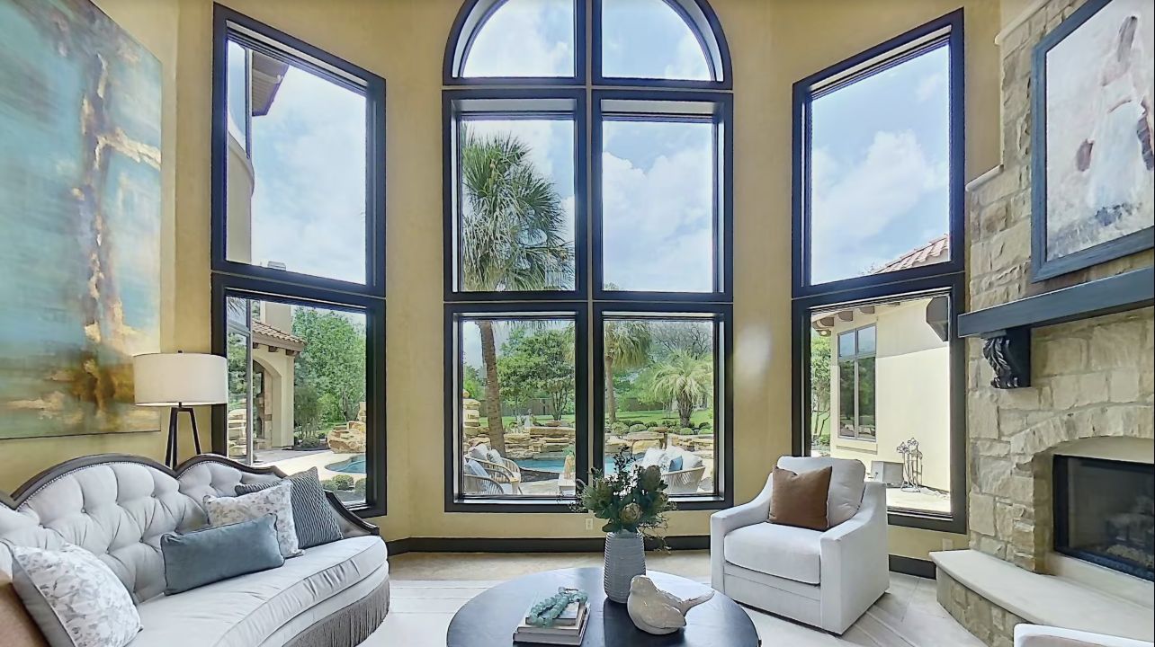 Living room with arched windows and pool view in the featured Zillow 3D Home tour
