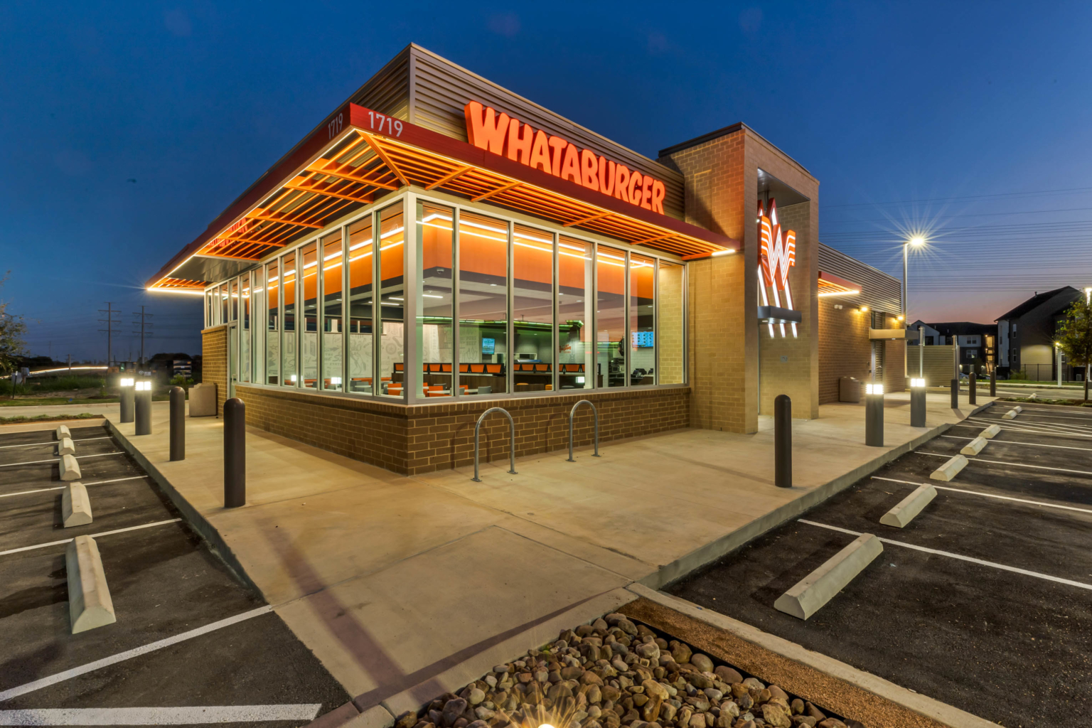 Illuminated commercial restaurant exterior photographed at dusk in Austin.